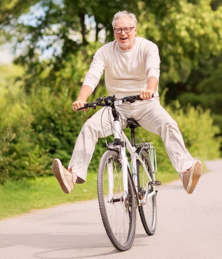 Blije oudere man op de fiets